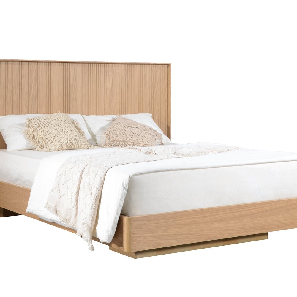 Wooden bed frame with white bedding and beige pillows on a white background